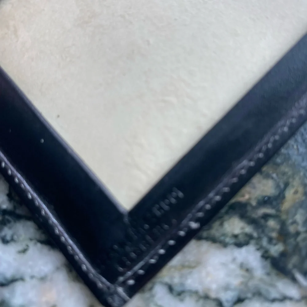 Black leather wallet gold embossed, folded classy.